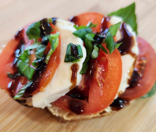 Caprese: sourdough bread, cream cheese,  basil, mozzarella, tomato slices and balsamic vinegar garnish. Sold in quantities of 8 or 20 sandwiches. Mix and match in a box!