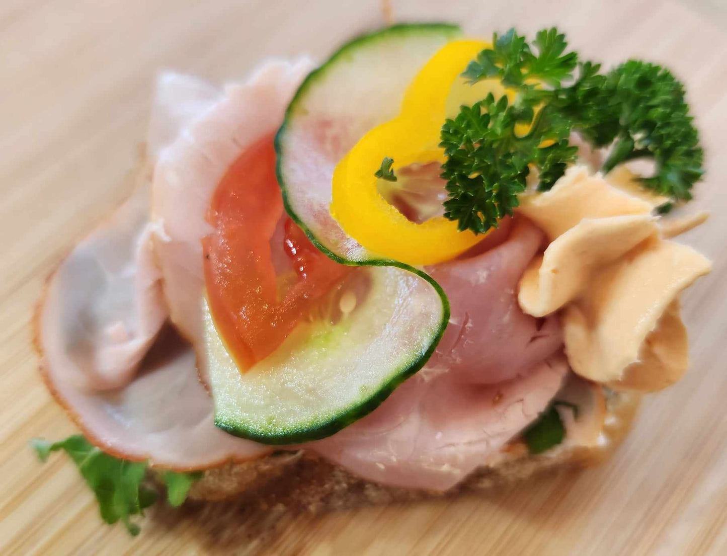 Ham sandwich: sourdough bread, cream cheese base, smoked ham, vegetable garnish. Sold in quantities of 8 or 20 sandwiches. Mix and match in a box!